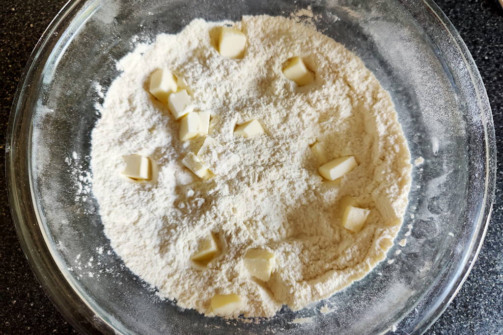 Buttermilk biscuit dry ingredients with cubed butter on top.